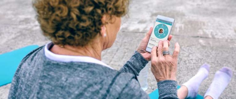 Woman on mobile phone looking at the Healow app